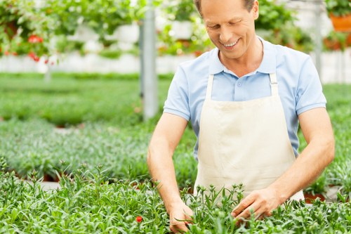 Worker wearing PPE while operating garden machinery